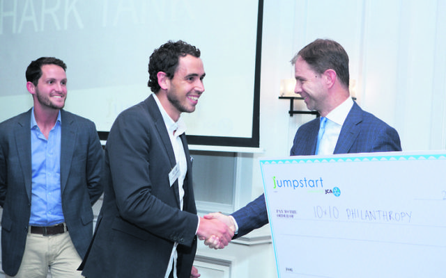 Laurie Marshbaum receives a cheque from Kelly+Partners' Brett Kelly last year.