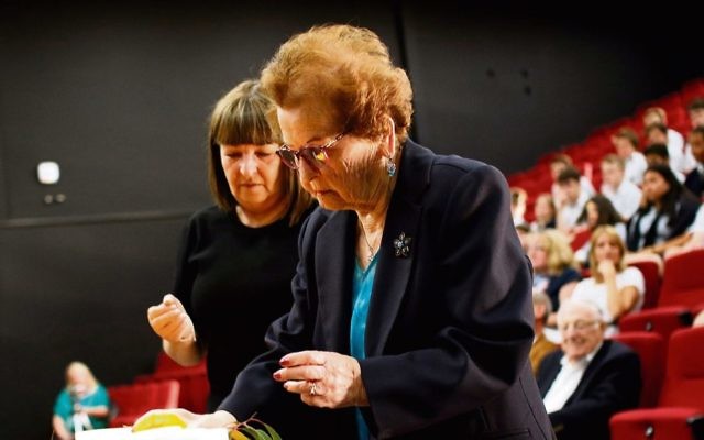 Survivor Edith Gluck lights a memorial candle with her daughter Donna at
Secondary College's Holocaust Remembrance Service. Photo: Peter Haskin Survivor Edith Gluck lights a memorial candle with her daughter Donna at
Secondary College's Holocaust Remembrance Service. Photo: Peter Haskin