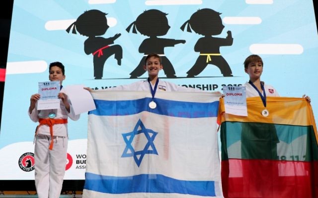 Gold medallist Sela Elmaliah holding the Israeli flag. Photo: Shachar Hoshmand