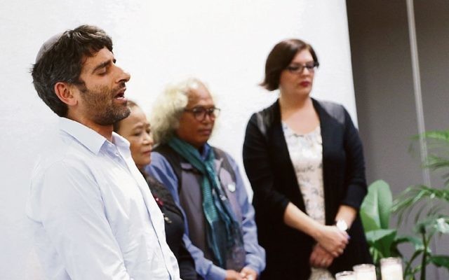Rabbi Shneur Reti-Waks reciting the El Male Rachamim prayer during a Yom Hashoah service. Photo: Peter Haskin