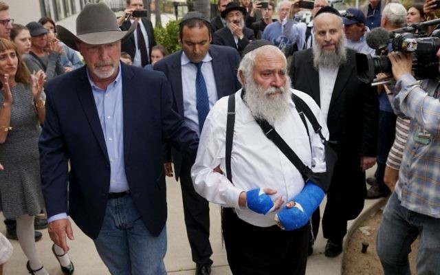 Rabbi Yisroel Goldstein, who was shot in the hands, walks towards a press conference with Poway Mayor Steve Vaus outside of the Chabad of Poway Synagogue in Poway, California on April 28, 2019. (SANDY HUFFAKER/AFP/Getty Images) Rabbi Yisroel Goldstein, who was shot in the hands, walks towards a press conference with Poway Mayor Steve Vaus outside of the Chabad of Poway Synagogue in Poway, California on April 28, 2019. (SANDY HUFFAKER/AFP/Getty Images)