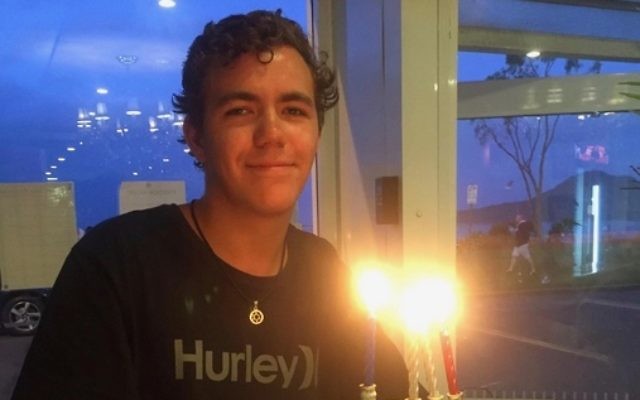 Kurt Brown lighting a menorah. Kurt Brown lighting a menorah.