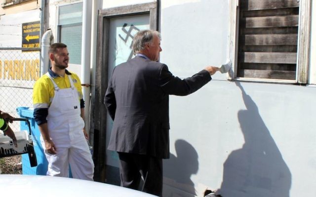 Bennelong MP John Alexander removing the graffiti in Epping. Photo: Facebook