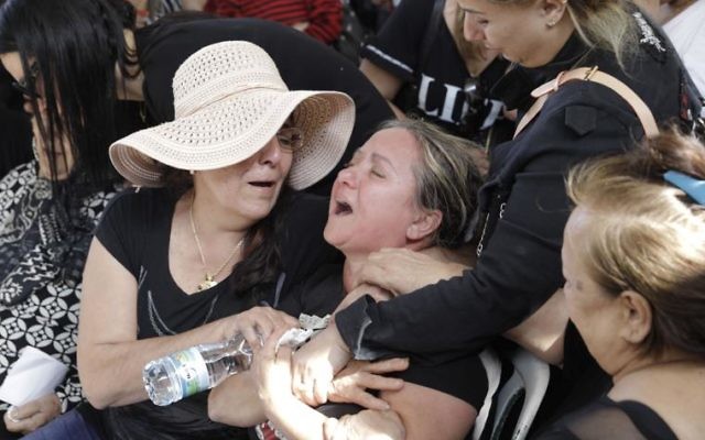The family of Moshe Agadi at his funeral in Ashkelon last Sunday. Photo: AP Photo/Sebastian Scheiner The family of Moshe Agadi at his funeral in Ashkelon last Sunday. Photo: AP Photo/Sebastian Scheiner