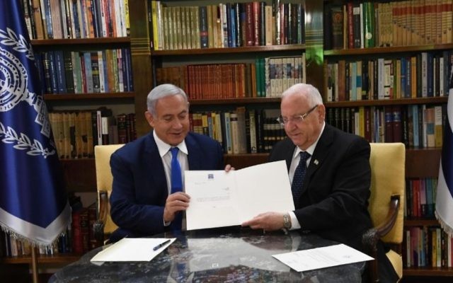 Israeli Prime Minister Benjamin Netanyahu and President Reuven Rivlin review the president's order giving Netanyahu two more weeks to form a government, on May 13, 2019. (Haim Zach/GPO)