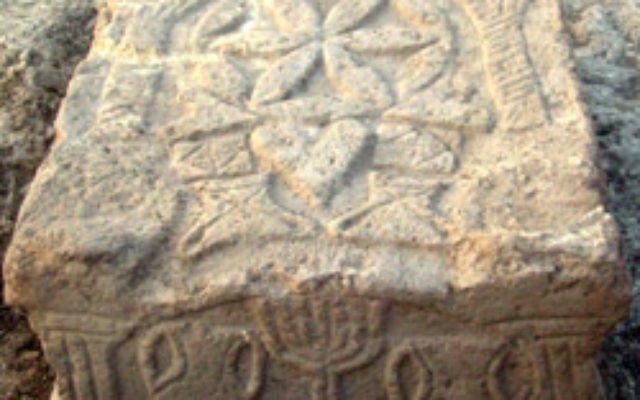A stone engraved with a menorah from a Second Temple period synagogue was excavated at Migdal in Israel. Photo: Isranet A stone engraved with a menorah from a Second Temple period synagogue was excavated at Migdal in Israel. Photo: Isranet