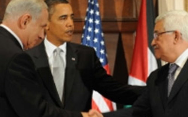 Israeli Prime Minister Benjamin Netanyahu (left) shakes hands with Palestinian Authority President Mahmoud Abbas in front of US President Barack Obama in New York on September 22. Photo: JTA