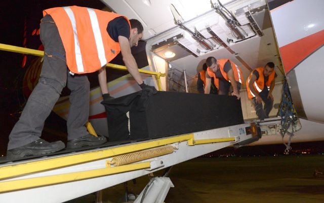 The coffins of the two Israeli victims were flown in to Tel Aviv. (Photo: Ashernet) The coffins of the two Israeli victims were flown in to Tel Aviv. (Photo: Ashernet)