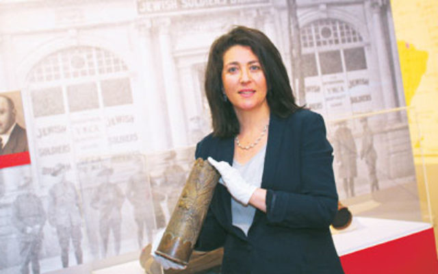 Curator Deborah Rechter holds a shell casing that was transformed into trench art during World War I. Photo: Peter Haskin Curator Deborah Rechter holds a shell casing that was transformed into trench art during World War I. Photo: Peter Haskin