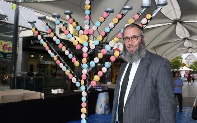 Rabbi Mendel Kastel next to the giant cupcake menorah at Jewish House's Chanukah party in Bondi Junction. Photo: Noel Kessel Rabbi Mendel Kastel next to the giant cupcake menorah at Jewish House's Chanukah party in Bondi Junction. Photo: Noel Kessel