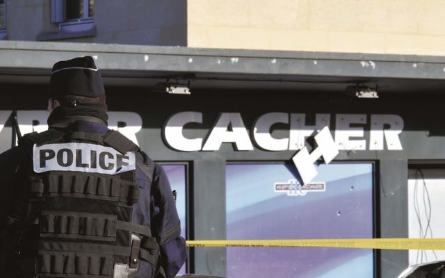 Police stand guard outside Hyper Cacher last January. Photo: Serge Attal/Flash90 Police stand guard outside Hyper Cacher last January. Photo: Serge Attal/Flash90