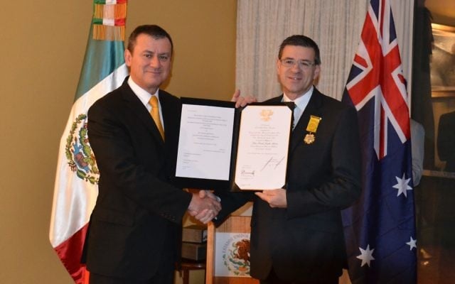 David Aarons (right) receives the Aztec Eagle award from Mexican ambassador Armando Alvarez. David Aarons (right) receives the Aztec Eagle award from Mexican ambassador Armando Alvarez.