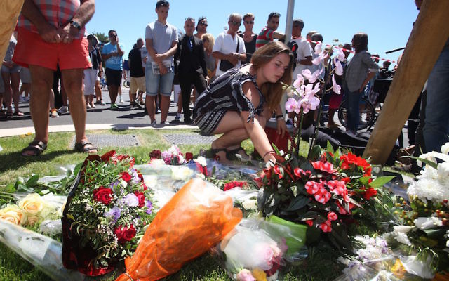 NICE, FRANCE - JULY 15: People visit the scene and lay tributes to the victims of a terror attack on the Promenade des Anglais on July 15, 2016 in Nice, France. NICE, FRANCE - JULY 15: People visit the scene and lay tributes to the victims of a terror attack on the Promenade des Anglais on July 15, 2016 in Nice, France.
