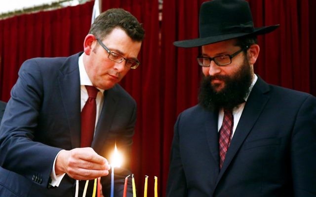 Victorian Premier Daniel Andrews lighting chanukiah candles with Rabbi Chaim Herzog. Photo: Peter Haskin Victorian Premier Daniel Andrews lighting chanukiah candles with Rabbi Chaim Herzog. Photo: Peter Haskin