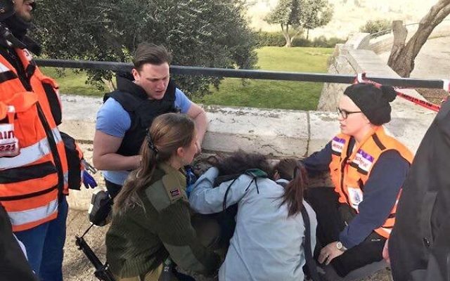 Dovi Meyer (back) helping to treat a victim of the January 8 terror attack in Jerusalem. Dovi Meyer (back) helping to treat a victim of the January 8 terror attack in Jerusalem.