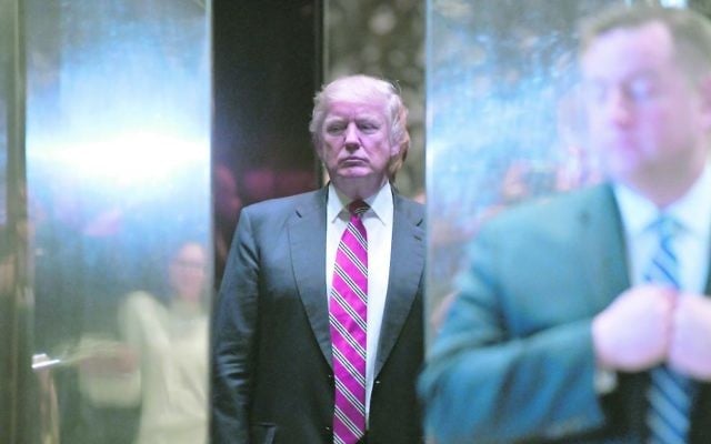 US President-elect Donald Trump stands inside the lobby elevator of Trump Tower. Photo: EPA/Anthony Behar/SIPA USA POOL. US President-elect Donald Trump stands inside the lobby elevator of Trump Tower. Photo: EPA/Anthony Behar/SIPA USA POOL.