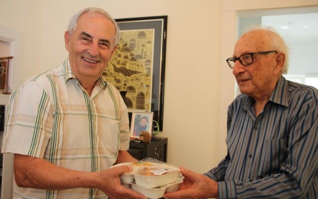 Volunteer Lou Levi delivers the one-millionth Kosher Meals on Wheels meal to Harry Lewis (right) last Friday. Photo: Shane Desiatnik Volunteer Lou Levi delivers the one-millionth Kosher Meals on Wheels meal to Harry Lewis (right) last Friday. Photo: Shane Desiatnik