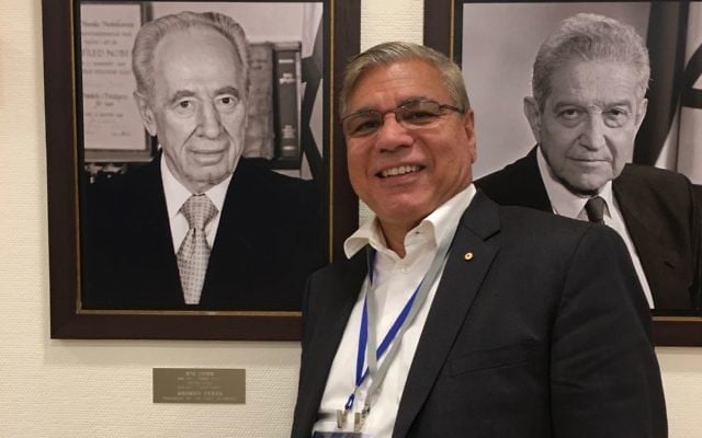 Nyunggai Warren Mundine during
a recent trip to Israel, in front of portraits of former presidents Shimon Peres and Ezer Weizman.
