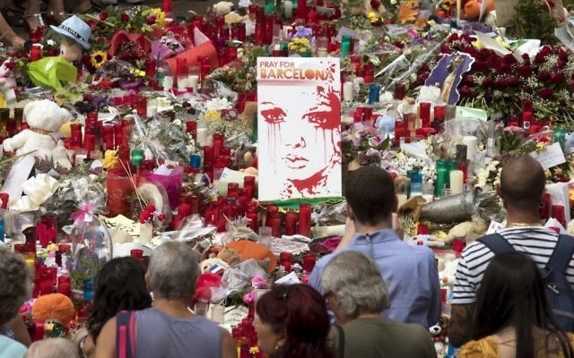 People pay their respect at the site of last week's deadly van attack. Photo: EPA/Marta Perez. People pay their respect at the site of last week's deadly van attack. Photo: EPA/Marta Perez.