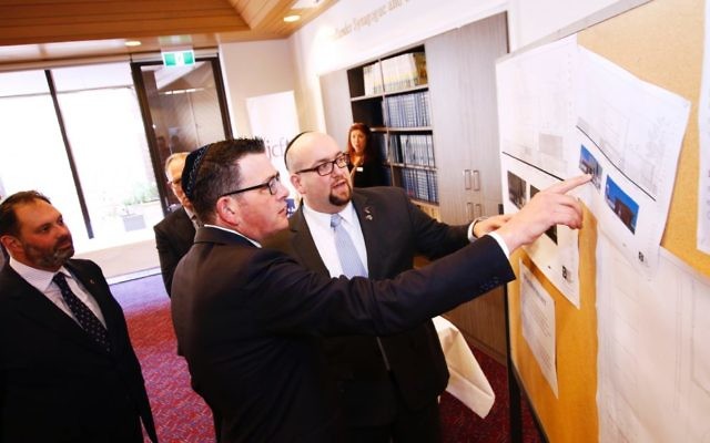 From left: Philip Dalidakis, Premier Daniel Andrews and Rabbi Gersh Lazarow study plans for the TBI upgrade during the Premier’s tour of the synagogue. Photo: Peter Haskin