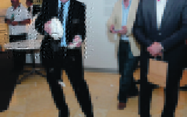Norman Seligman and Dr Stavros Kyrimis throwing plates at the launch of the Jews of Greece exhibition at the Sydney Jewish Museum on October 24. Photo: Giselle Haber