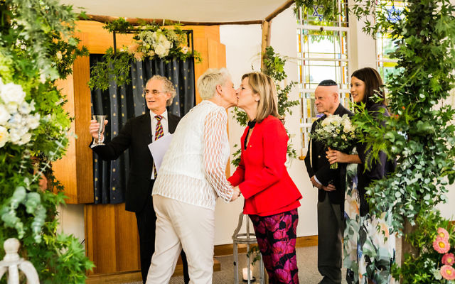 L'chaim! Dr Kerryn Phelps (left) kissing her wife Jackie Stricker-Phelps after the ceremony at Emanuel Synagogue last week. Photo: Same Love Photography L'chaim! Dr Kerryn Phelps (left) kissing her wife Jackie Stricker-Phelps after the ceremony at Emanuel Synagogue last week. Photo: Same Love Photography