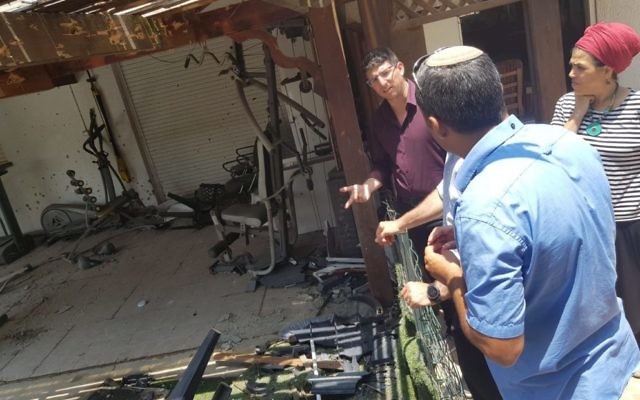 Sderot locals review the damage caused by a rocket. Photo: Sderot Municipality