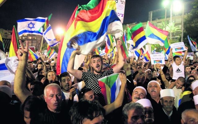 Thousands joined the Druze protest against the new law on Saturday night in Tel Aviv. Photo: AP Photo/Sebastian Scheiner Thousands joined the Druze protest against the new law on Saturday night in Tel Aviv. Photo: AP Photo/Sebastian Scheiner