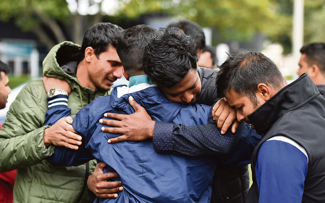 Friends of a missing man grieve outside a refuge centre in Christchurch last Sunday. Photo: AAP Image/Mick Tsikas Friends of a missing man grieve outside a refuge centre in Christchurch last Sunday. Photo: AAP Image/Mick Tsikas