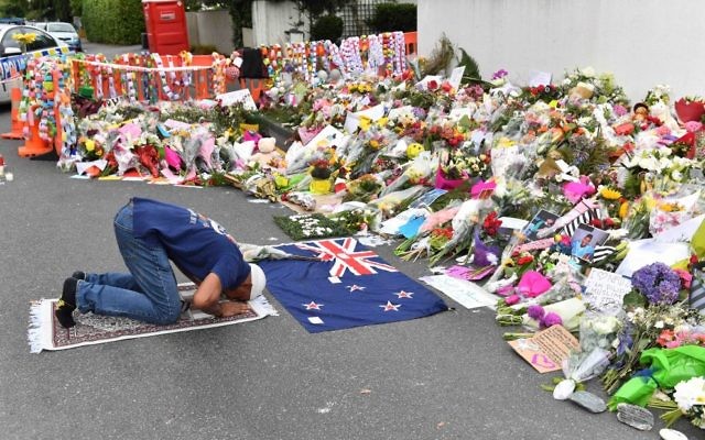 A Muslim worshipper prays at a makeshift memorial near the Al Noor Mosque
in Christchurch. Photo: AAP Image/Mick Tsikas A Muslim worshipper prays at a makeshift memorial near the Al Noor Mosque
in Christchurch. Photo: AAP Image/Mick Tsikas