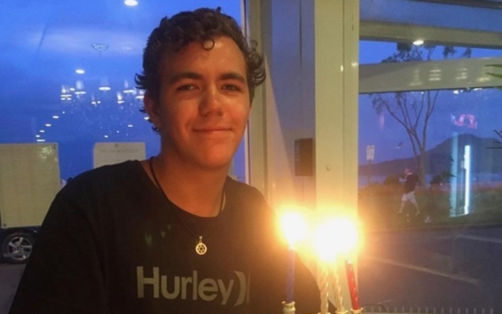 Kurt Brown lighting a menorah. Kurt Brown lighting a menorah.