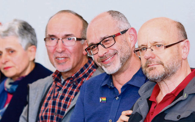 A beaming Michael Barnett (second from right) of Aleph Melbourne with
husband Gregory Storer (right) after the historic apology motion was
accepted at Monday night’s JCCV plenum. Photo: Peter Haskin A beaming Michael Barnett (second from right) of Aleph Melbourne with
husband Gregory Storer (right) after the historic apology motion was
accepted at Monday night’s JCCV plenum. Photo: Peter Haskin