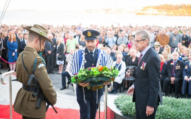 Rabbi Yossi Friedman laying a wreath at the service.