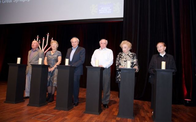 Holocaust survivors light the memorial candles. Photo: Giselle Haber