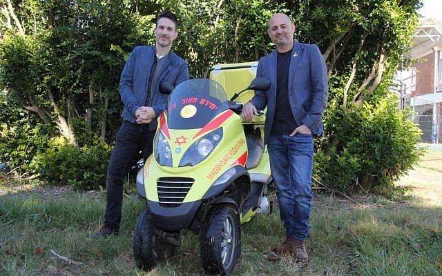 Jason Spinak (left) and MDA NSW CEO Doron Lazarus with a medicycle like the one bearing Jeremy Spinak's name. Photo: Gareth Narunsky.