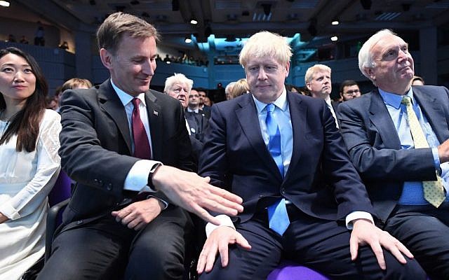 Foreign Secretary Jeremy Hunt, left, extending a hand to congratulate Boris Johnson for being elected as the new leader of the Conservative Party and British Prime Minister in London, July 23, 2019. (Stefan Rousseau - WPA Pool/Getty Images)