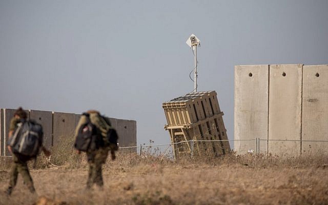 Israeli soldiers walk near an Iron Dome anti-missile battery in the southern Israeli city of Sderot, Aug. 9, 2018. (Yonatan Sindel/Flash90) Israeli soldiers walk near an Iron Dome anti-missile battery in the southern Israeli city of Sderot, Aug. 9, 2018. (Yonatan Sindel/Flash90)