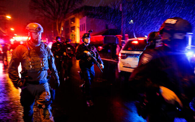 Law enforcement personnel walk near the scene of a shooting in Jersey City, New Jersey, Dec. 10, 2019. (AP Photo/Eduardo Munoz Alvarez) Law enforcement personnel walk near the scene of a shooting in Jersey City, New Jersey, Dec. 10, 2019. (AP Photo/Eduardo Munoz Alvarez)