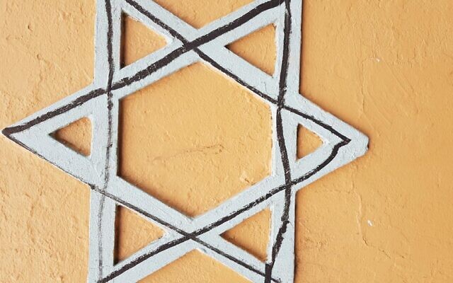 The Star of David defaced with a
black marker. The Star of David defaced with a
black marker.