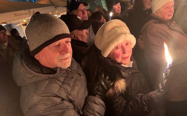 Yvonne Engelman, pictured with her son Michael, holds a candle during a
havdalah service in Krakow last week. Yvonne Engelman, pictured with her son Michael, holds a candle during a
havdalah service in Krakow last week.
