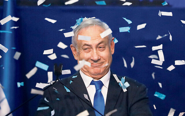 Israeli Prime Minister Benjamin Netanyahu in celebratory mood after the first exit poll results were released on
Monday evening. Photo: AP Photo/Ariel Schalit Israeli Prime Minister Benjamin Netanyahu in celebratory mood after the first exit poll results were released on
Monday evening. Photo: AP Photo/Ariel Schalit