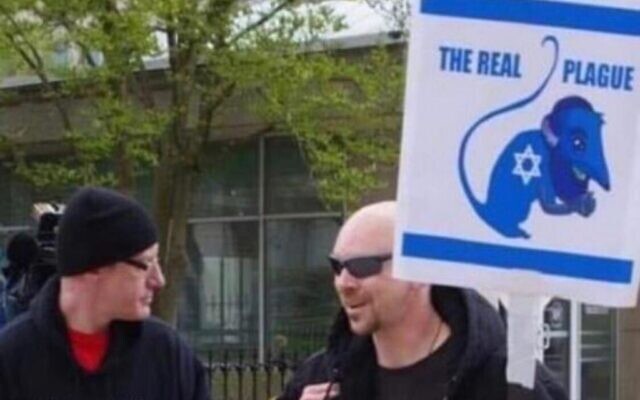 A placard reading ‘The real plague’, depicting a Jew as a rat, brandished at an anti-lockdown protest in Ohio.
Photo: Twitter A placard reading ‘The real plague’, depicting a Jew as a rat, brandished at an anti-lockdown protest in Ohio.
Photo: Twitter