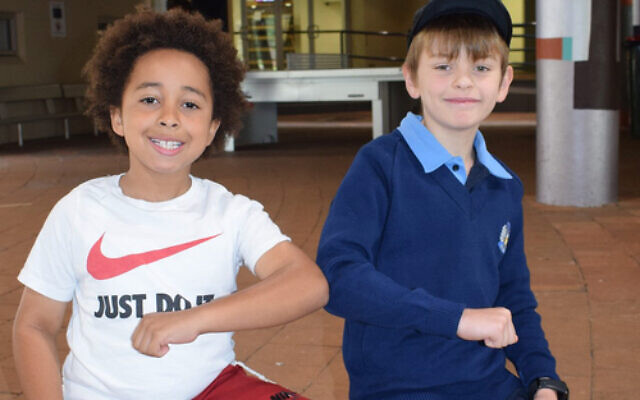 Elbow exchange: Masada College primary students Izaac Wyzenbeek (left) and Aleksay Berry were happy to return to
school last week. Normal classes begin resuming on Monday. Elbow exchange: Masada College primary students Izaac Wyzenbeek (left) and Aleksay Berry were happy to return to
school last week. Normal classes begin resuming on Monday.