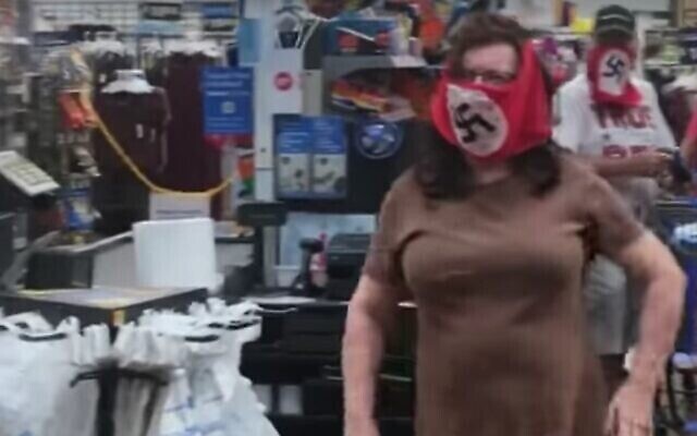 Screen capture from video of a man and woman wearing swastika face masks as they shop at a Walmart in Minnesota, July 25, 2020. Screen capture from video of a man and woman wearing swastika face masks as they shop at a Walmart in Minnesota, July 25, 2020.