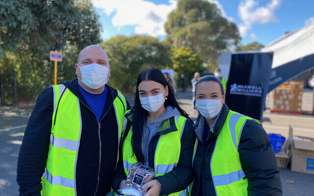 Tony Lotzof (left) at a collection point with daughter Amber (centre) and wife
Toni. Tony Lotzof (left) at a collection point with daughter Amber (centre) and wife
Toni.