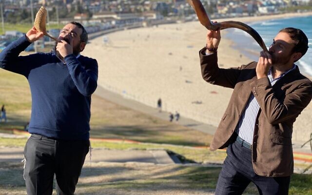 Rabbis Eli Schlanger and Yossi Friedman blowing shofars at Sydney’s Bondi
Beach in a previous year. Rabbis Eli Schlanger and Yossi Friedman blowing shofars at Sydney’s Bondi
Beach in a previous year.