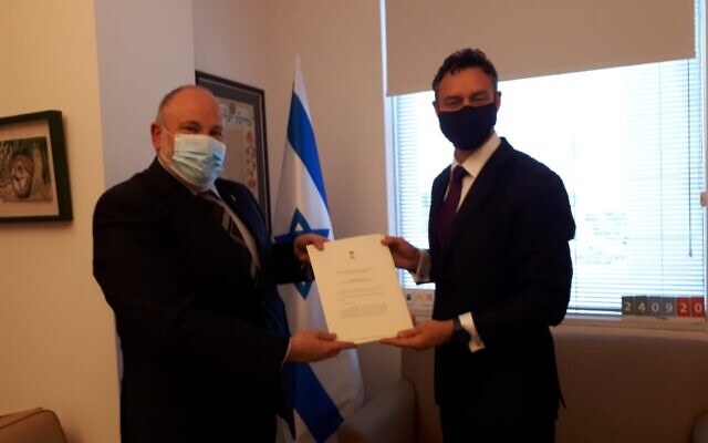 Paul Griffiths (right) presents copies of his credentials to Israeli Chief of State Protocol Meron Reuben. Paul Griffiths (right) presents copies of his credentials to Israeli Chief of State Protocol Meron Reuben.