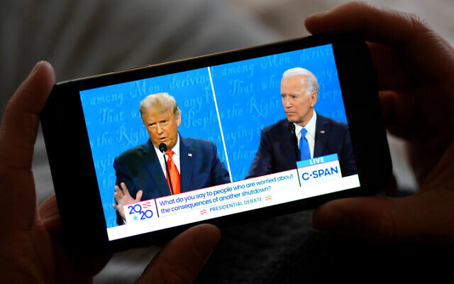 Watching last week’s presidential debate on a smartphone. Photo: Dreamstime.com Watching last week’s presidential debate on a smartphone. Photo: Dreamstime.com
