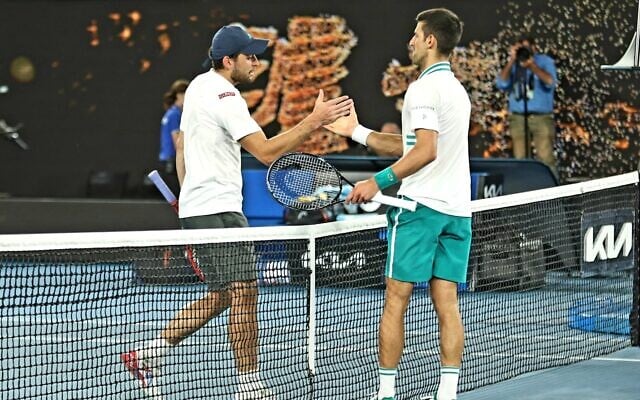 Aslan Karatsev shakes hands with Novak Djokovic at the Australian Open semi-final on Thursday night. Photo: Peter Haskin Aslan Karatsev shakes hands with Novak Djokovic at the Australian Open semi-final on Thursday night. Photo: Peter Haskin