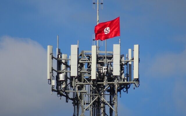 A Nazi flag attached to a phone tower in the the Victorian town of Kyabram last April.
Photo: Twitter A Nazi flag attached to a phone tower in the the Victorian town of Kyabram last April.
Photo: Twitter
